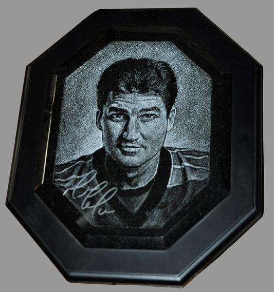 Portrait of a man in a black frame on a wooden surface